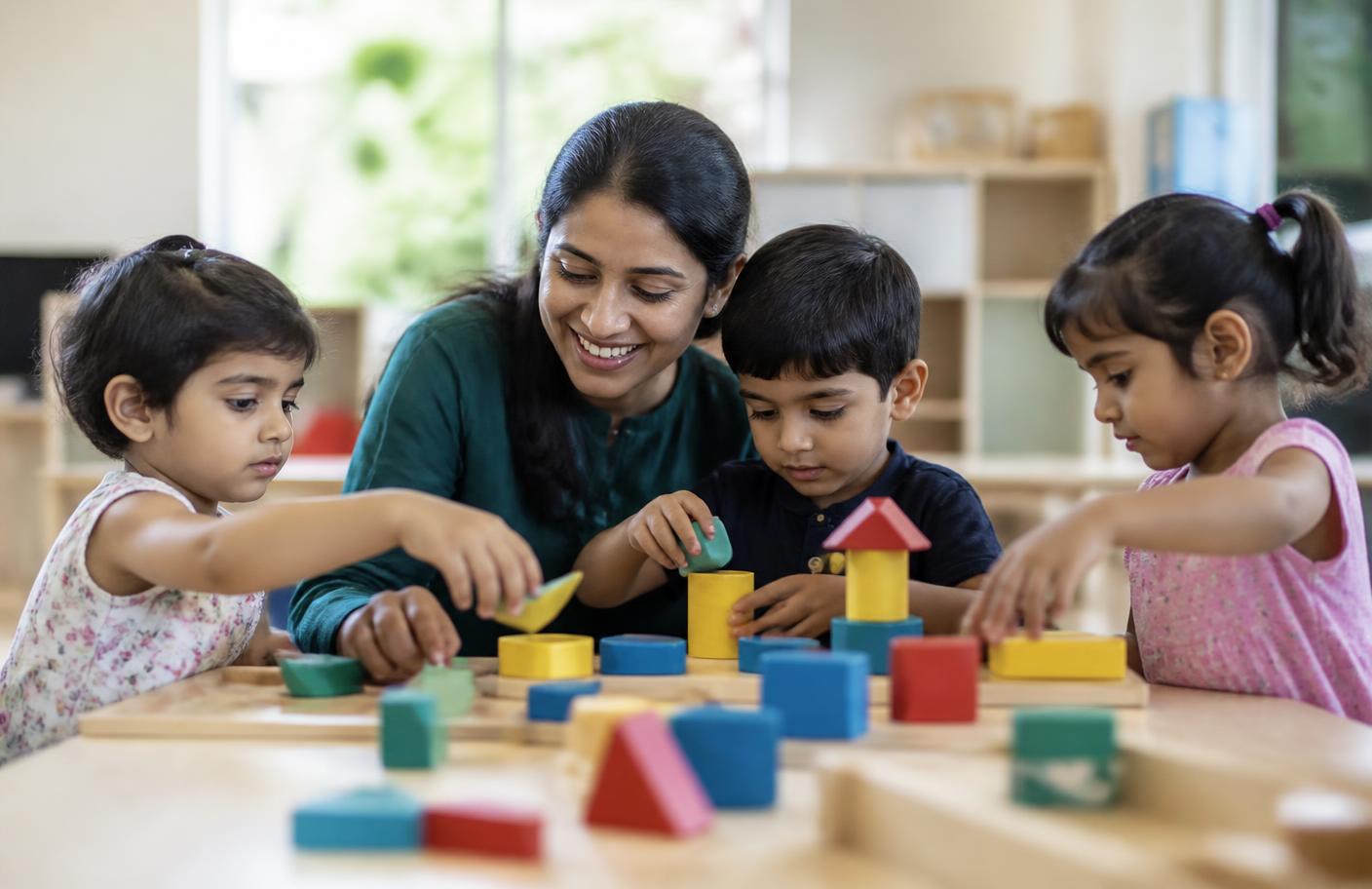 Indian preschool children exploring hands-on learning materials with their teacher